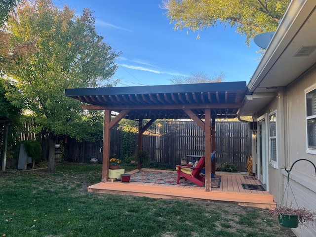 view of yard featuring a deck, a fenced backyard, and a pergola