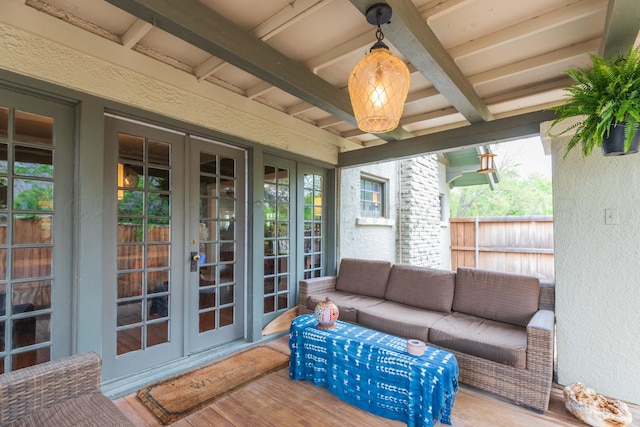 sunroom with french doors, an outdoor hangout area, healthy amount of natural light, and beamed ceiling