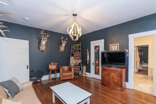 living area with a chandelier and wood finished floors