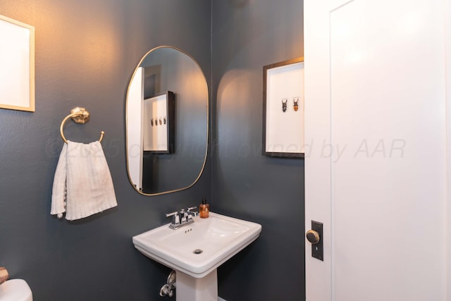 half bathroom featuring a sink