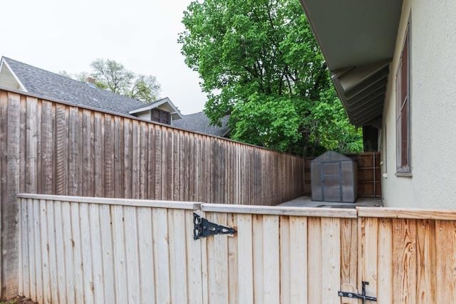 view of yard with a shed, fence, and an outbuilding