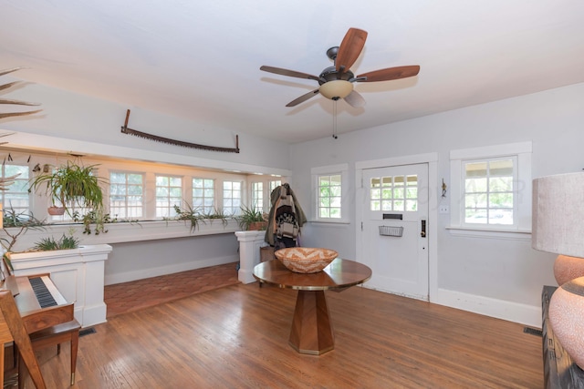 entryway featuring baseboards, ceiling fan, and wood finished floors