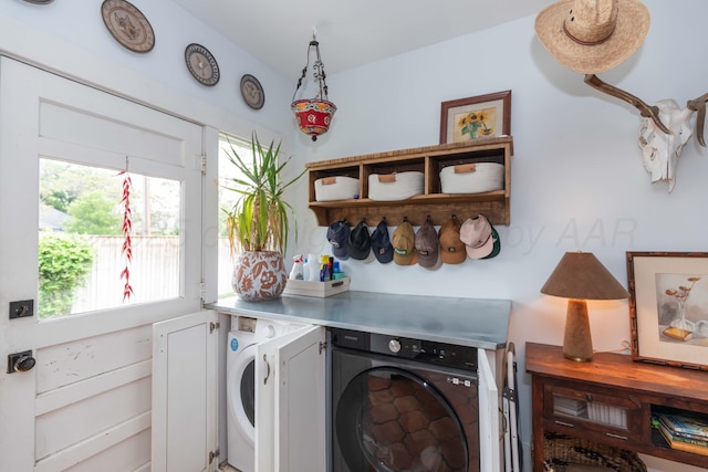 laundry area with washer and clothes dryer and healthy amount of natural light