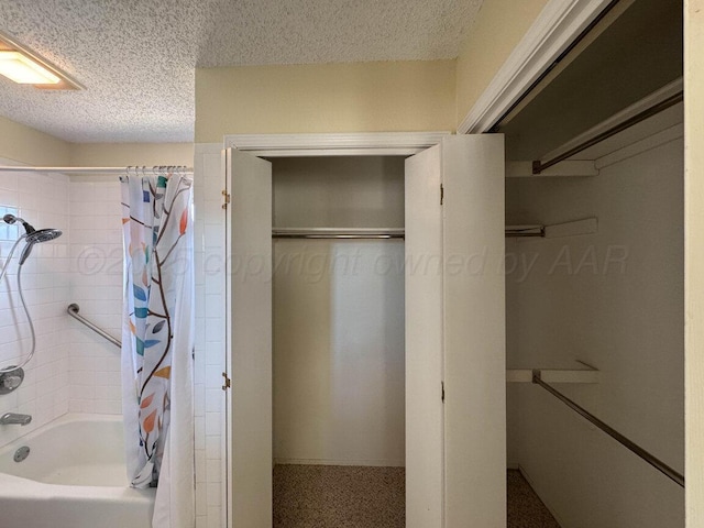 full bath with a textured ceiling, shower / bathtub combination with curtain, and a closet