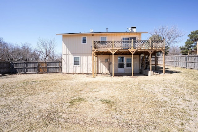 rear view of house featuring a fenced backyard, stairway, and a deck