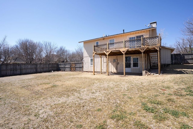 rear view of house with a fenced backyard, a wooden deck, and board and batten siding