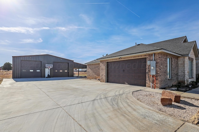 view of front facade with an outbuilding, a front yard, and a garage