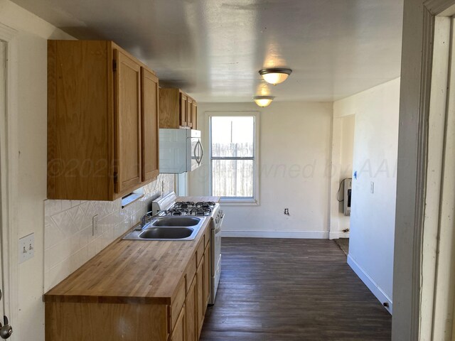 409 N Alabama St, Amarillo, TX 79106 - kitchen featuring a sink, baseboards, white appliances, dark wood-type flooring, and butcher block countertops