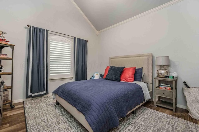 bedroom with crown molding, lofted ceiling, wood finished floors, and baseboards