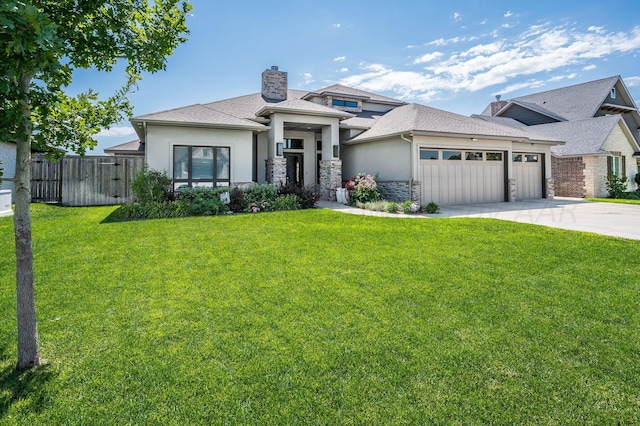 prairie-style home featuring a garage and a front lawn