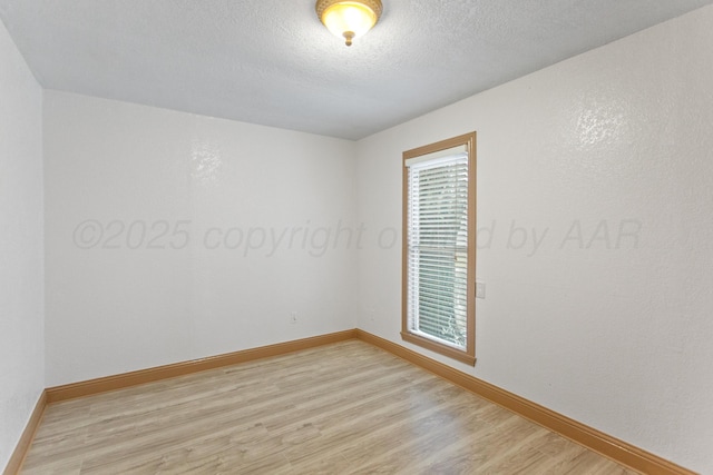 431 Crest, Pampa, TX 79065 - spare room with light wood-style flooring, baseboards, and a textured ceiling