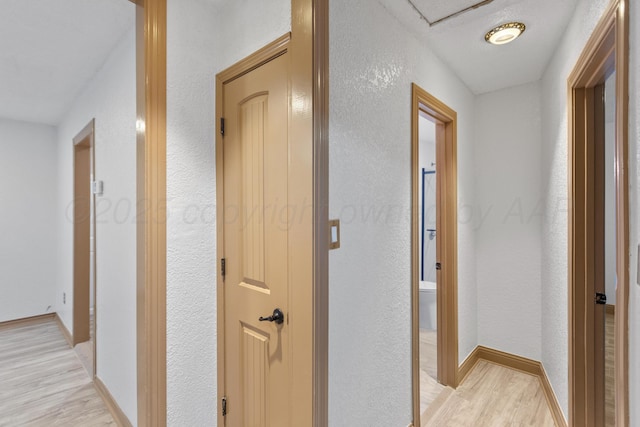 431 Crest, Pampa, TX 79065 - corridor with light wood-style floors, a textured wall, and baseboards