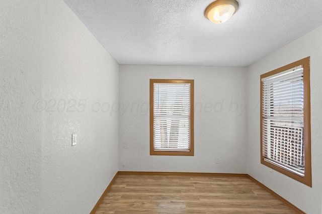 431 Crest, Pampa, TX 79065 - empty room with light wood-style floors, a textured ceiling, and baseboards