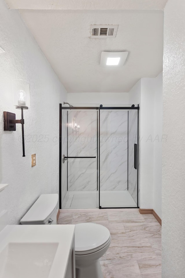 431 Crest, Pampa, TX 79065 - bathroom with a textured wall, toilet, a marble finish shower, vanity, and marble look tiles