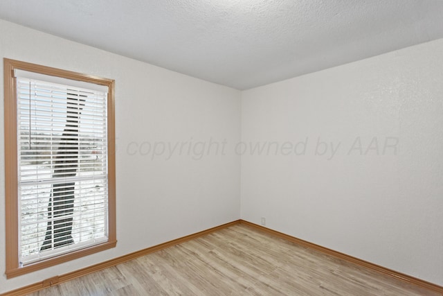 431 Crest, Pampa, TX 79065 - empty room with light wood-type flooring, baseboards, and plenty of natural light