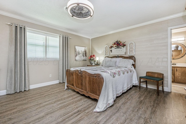 227 Ranger St, Hereford, TX 79045 - bedroom featuring wood finished floors, crown molding, baseboards, ensuite bathroom, and a sink