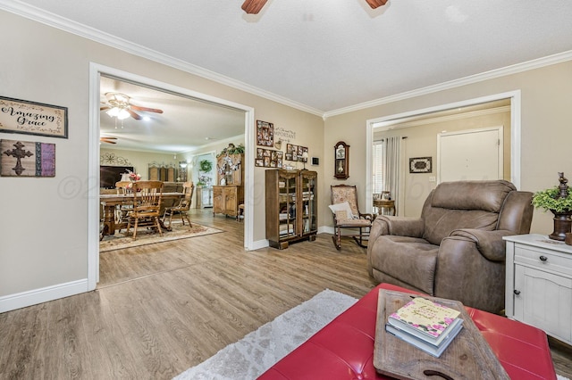 227 Ranger St, Hereford, TX 79045 - living room featuring a ceiling fan, ornamental molding, wood finished floors, and baseboards