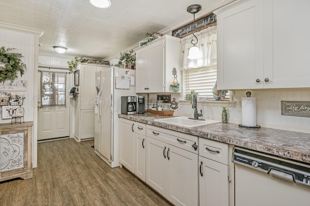 227 Ranger St, Hereford, TX 79045 - kitchen with a sink, white appliances, white cabinetry, wood finished floors, and ornamental molding