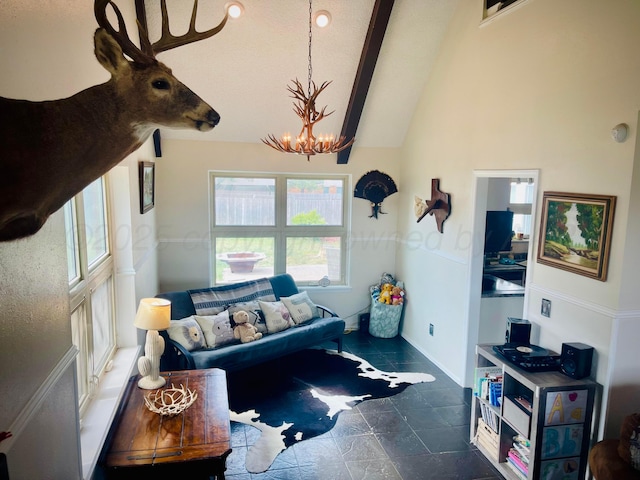 145 Pioneer Dr, Booker, TX 79005 - living room featuring a chandelier, baseboards, and lofted ceiling