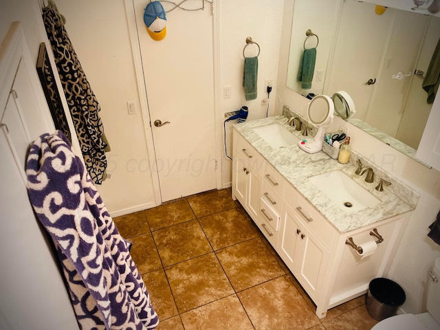 145 Pioneer Dr, Booker, TX 79005 - full bath with toilet, tile patterned flooring, a sink, and double vanity