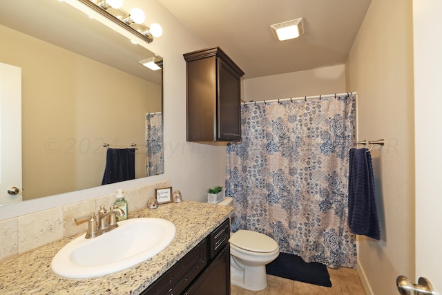 bathroom featuring toilet, vanity, decorative backsplash, and tile patterned floors