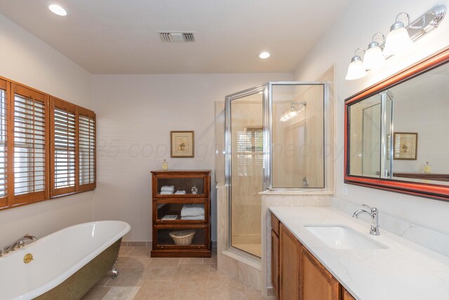 3616 Van Tassel St, Amarillo, TX 79121 - full bathroom with a freestanding bath, a shower stall, vanity, tile patterned flooring, and recessed lighting