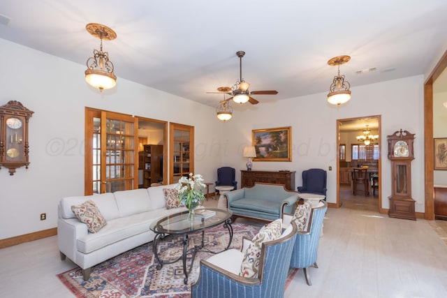 3616 Van Tassel St, Amarillo, TX 79121 - living room featuring a chandelier, baseboards, light wood-style floors, and a ceiling fan