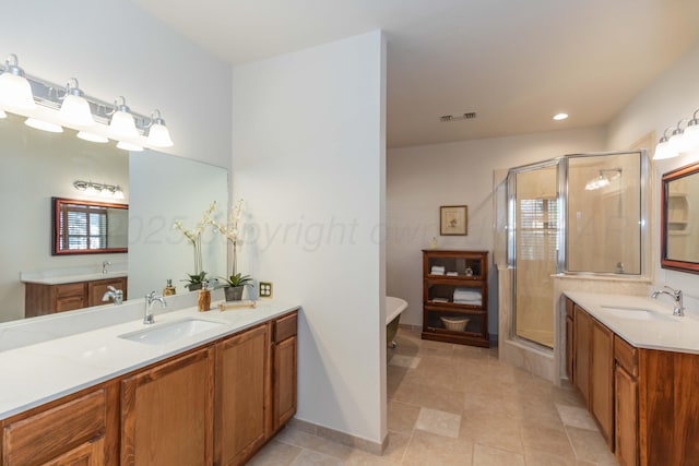 3616 Van Tassel St, Amarillo, TX 79121 - bathroom featuring two vanities, a shower stall, a soaking tub, healthy amount of natural light, and recessed lighting