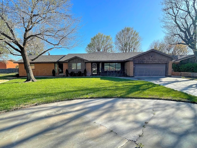 single story home featuring a garage and a front lawn