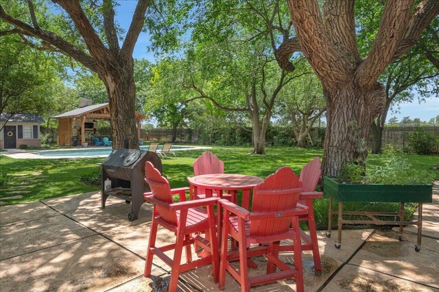 100 S Avondale St, Amarillo, TX 79106 - view of patio featuring an outdoor pool, an outdoor structure, and area for grilling
