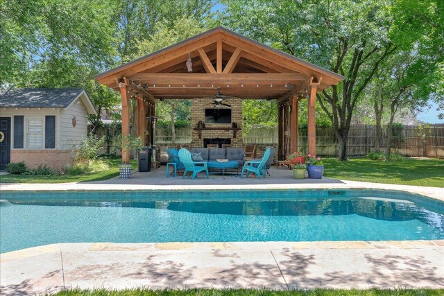 100 S Avondale St, Amarillo, TX 79106 - view of swimming pool with a fenced backyard, a gazebo, an outdoor structure, ceiling fan, and an outdoor living space with a fireplace