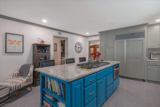 100 S Avondale St, Amarillo, TX 79106 - kitchen with paneled built in refrigerator, stainless steel gas stovetop, a center island, crown molding, and recessed lighting