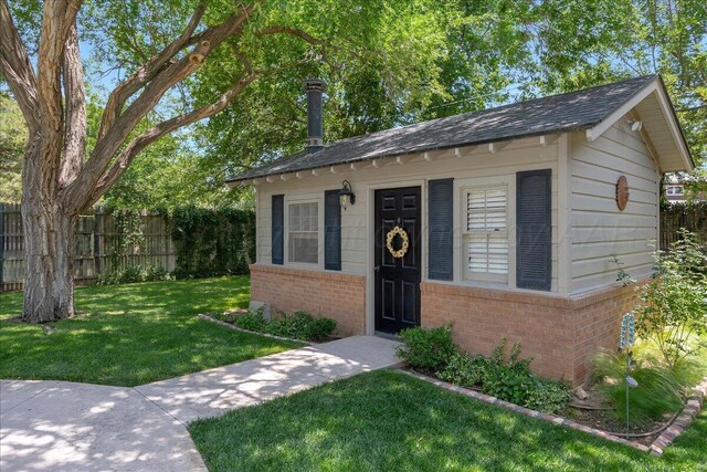 100 S Avondale St, Amarillo, TX 79106 - view of front of property with brick siding, an outbuilding, and a shingled roof