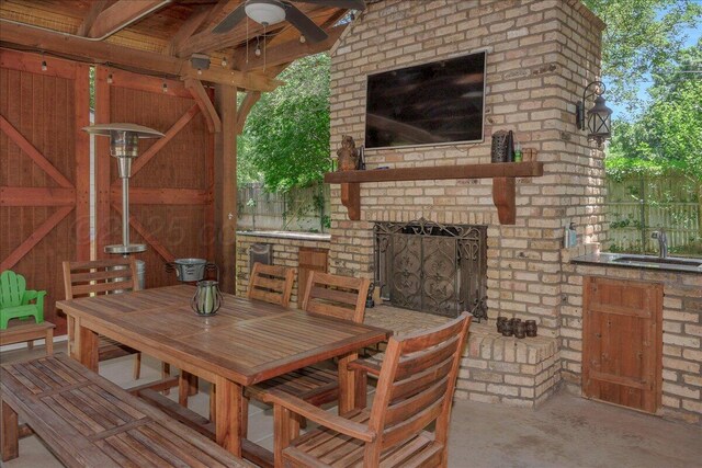 100 S Avondale St, Amarillo, TX 79106 - view of patio / terrace with an outdoor brick fireplace, outdoor dining area, and an outdoor kitchen