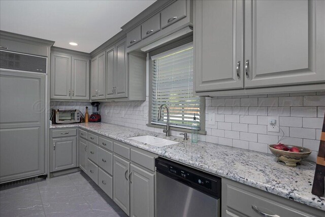 100 S Avondale St, Amarillo, TX 79106 - kitchen with stainless steel dishwasher, gray cabinetry, paneled built in fridge, decorative backsplash, and light stone counters