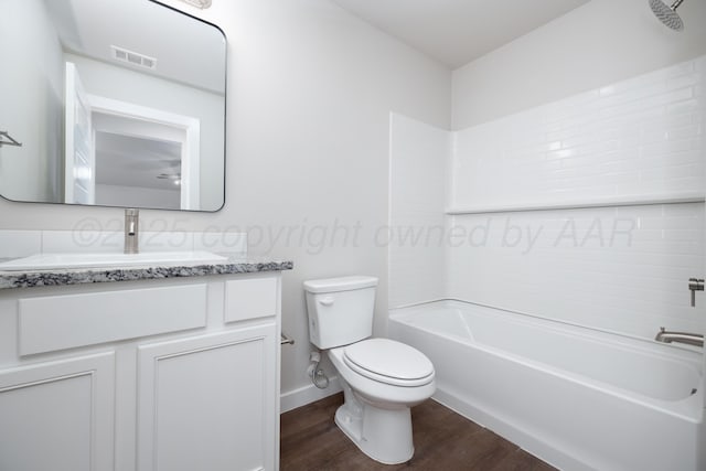 7607 Castleman Rd, Amarillo, TX 79119 - full bath featuring wood finished floors, vanity, and washtub / shower combination