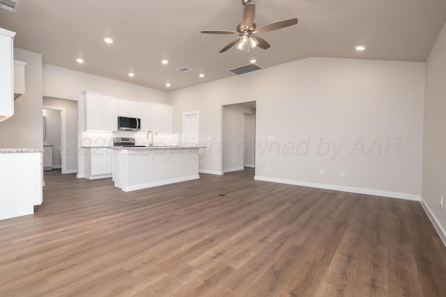 7607 Castleman Rd, Amarillo, TX 79119 - unfurnished living room with ceiling fan, recessed lighting, wood finished floors, and lofted ceiling