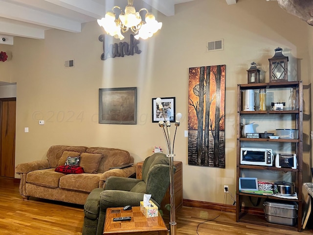 living room featuring wood-type flooring, beam ceiling, and a notable chandelier