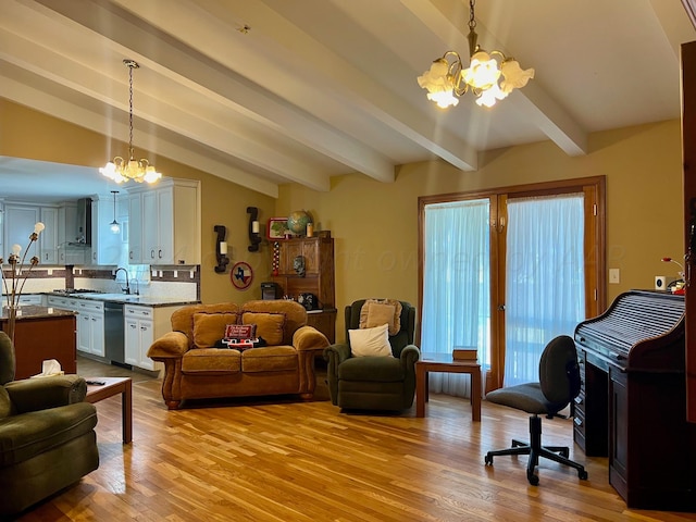 living room with light wood-type flooring, lofted ceiling with beams, a chandelier, and sink