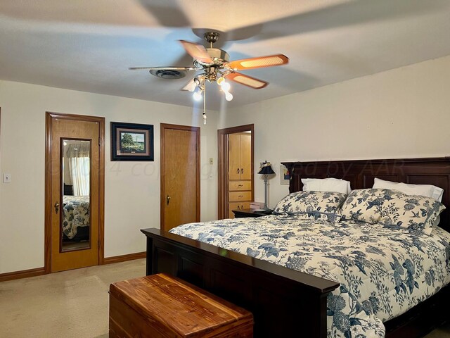 bedroom featuring ceiling fan and light colored carpet