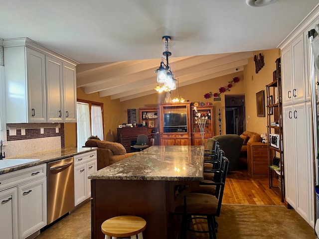 kitchen with lofted ceiling with beams, light wood-type flooring, a kitchen bar, dark stone countertops, and stainless steel dishwasher