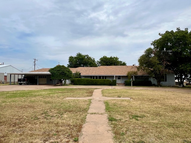 ranch-style house featuring a carport and a front yard