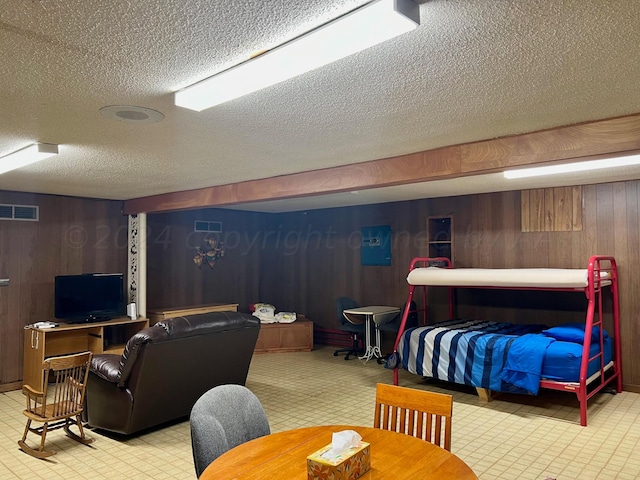 interior space with wooden walls and a textured ceiling