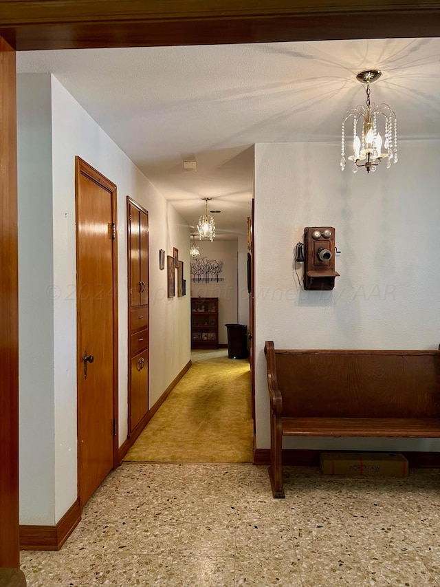 corridor with a notable chandelier