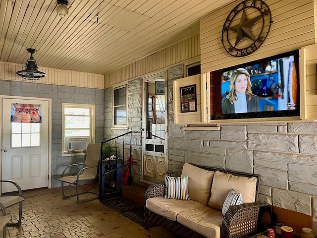 1814 N Main St, Shamrock, TX 79079 - living area with cooling unit, brick patterned floors, wooden walls, and wood ceiling