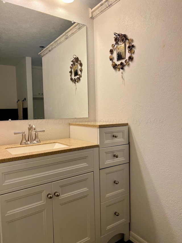 bathroom with vanity and a textured ceiling