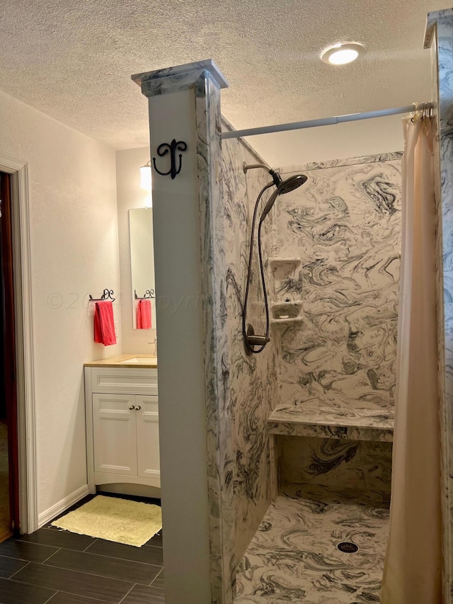 bathroom featuring vanity, a textured ceiling, and a shower with curtain