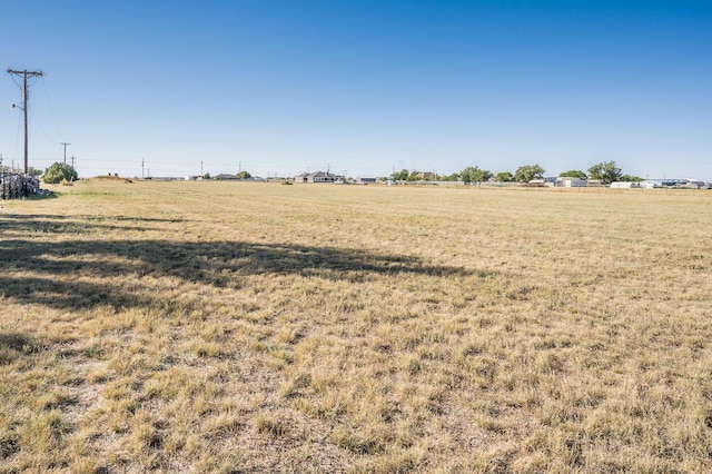 view of yard with a rural view