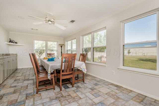 dining space with a wealth of natural light, crown molding, and ceiling fan