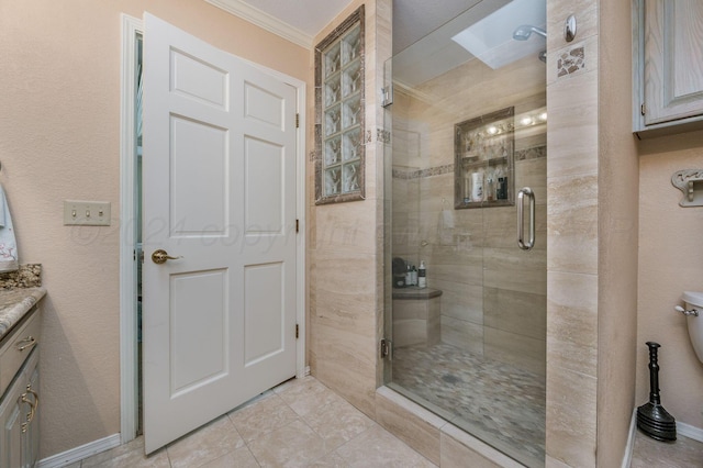bathroom with a shower with door, vanity, and ornamental molding